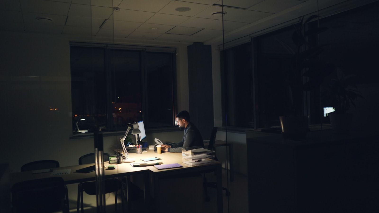 A working desk lit late in the evening